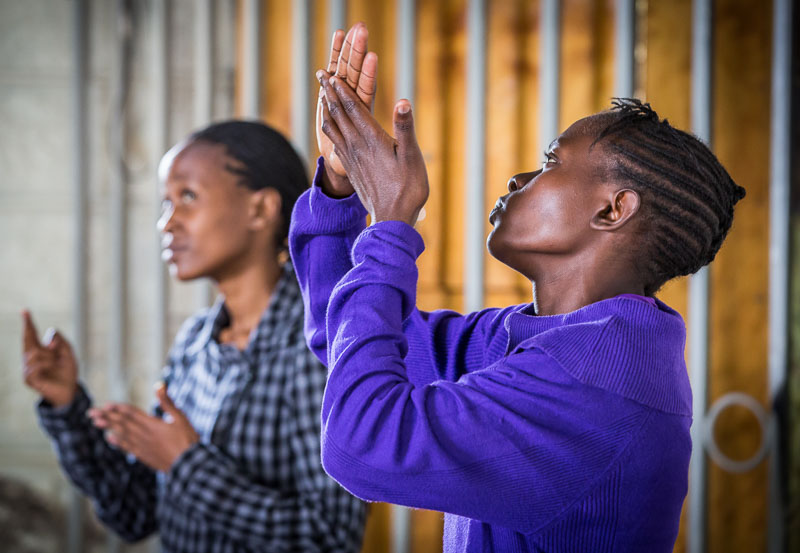 Mercy Mideva and another woman lead worship in Kenyan Sign Language